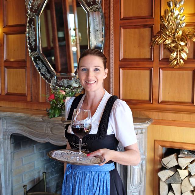 Frau Sonja Weiss mit einem Rotwein im Hotel im Allgäu